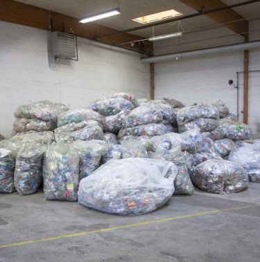 Thousands of plastic bottles compacted 90%