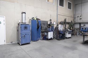 Baler positioned against a wall in an industrial environment